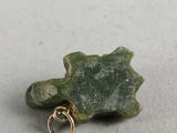 a close up of a piece of stone with a gold ring on it