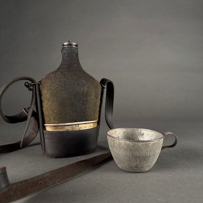 a bottle and a bowl sitting next to each other on a table