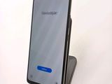 a cell phone that is sitting on top of a stand
