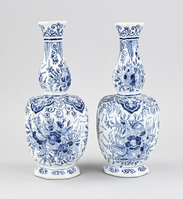 pair of blue and white vases with floral designs on them