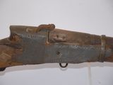 a close up of a rifle with a wooden handle on display