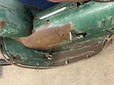 a green scooter that is sitting on the ground