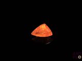 an orange diamond in the dark with a black background