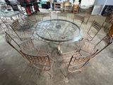 a glass table with chairs around it in a garage