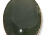 un gros plan d'un objet rond vert posé sur une surface blanche