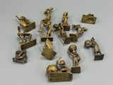 a lot of bronze figurines that are sitting on a table
