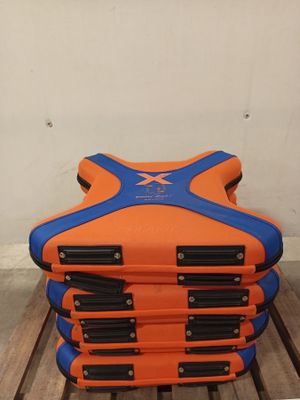 a stack of orange and blue luggage sitting on a wooden table