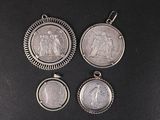 three silver pendants with a picture of jesus and mary on them