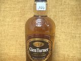 une photo d'une bouteille de whisky Glen Turner posée sur une table