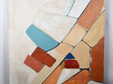 abstract painting on a canvas with a red, orange, blue, and white design