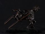 bronze statue of a boy with a stick and a dog on a black background