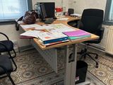a desk with a chair and a computer on it