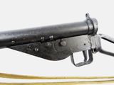 an old machine gun with a yellow cord attached to it