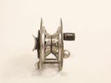 an image of a metal reel with a spool on a white surface
