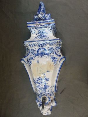 a blue and white vase with a bird on it