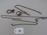 a lot of silver jewelry on a table with a price tag