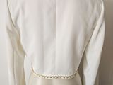 a close up of a mannequin torso with a white jacket on it