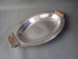a silver plate with a wooden handle on a table
