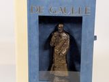 statue of a man in a box on a white surface