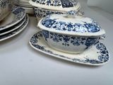 many plates and bowls with blue and white designs on them
