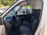 the interior of a white van with black seats and a steering wheel