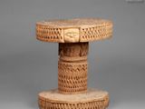 a close up of a small table with carvings on it