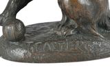 bronze statue of a dog with a ball in its mouth