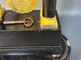 a clock that is sitting on a table with a key