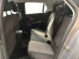 the back seats of a car with a bottle of soda in it
