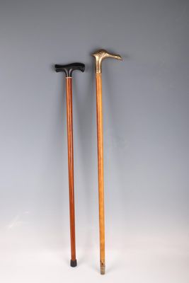 a pair of walking sticks with wooden handles on a white background