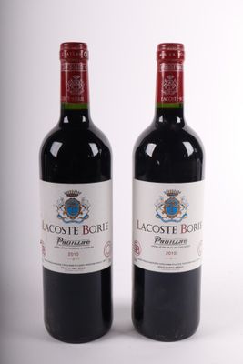 two bottles of red wine sitting next to each other on a white surface