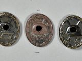 three different types of coins are shown on a white surface