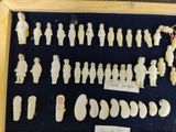 a lot of small figurines in a display case