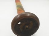 a wooden pipe that is sitting on a white surface