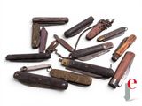 many different types of pocket knives on a white surface