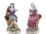 pair of porcelain figurines of a woman and a dog