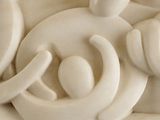 a sculpture of a group of people sitting on a table