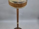 an image of a brass plate on a stand with a wooden base