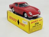 a red toy car sitting on top of a box