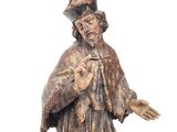 an image of a statue of a man with a hat and a robe