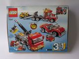 a box of legos with a fire truck and other vehicles
