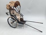 an old fashioned carriage with two seats and a canopy on the back