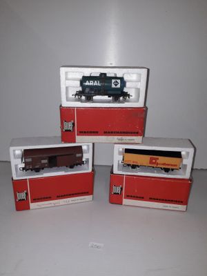 three toy trains sitting on top of each other on a table