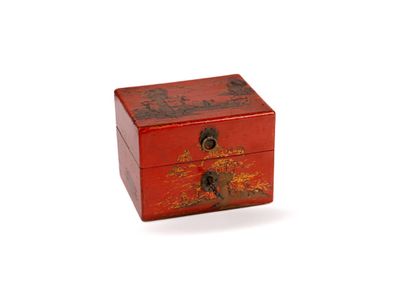 a small wooden box with a red design on it