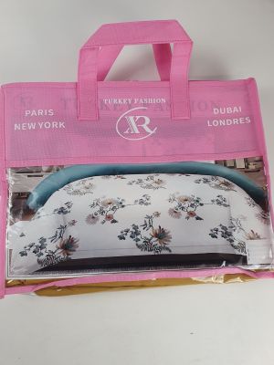 packaging of a pink purse with a floral pattern on it