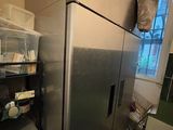 an image of a refrigerator in a kitchen with a lot of stuff on the shelves