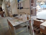 a table with a lot of boxes on it in a warehouse