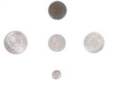 a lot of coins that are on a white surface