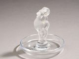 a glass figurine of a horse on a glass plate