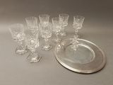 many glasses and a silver plate on the table
